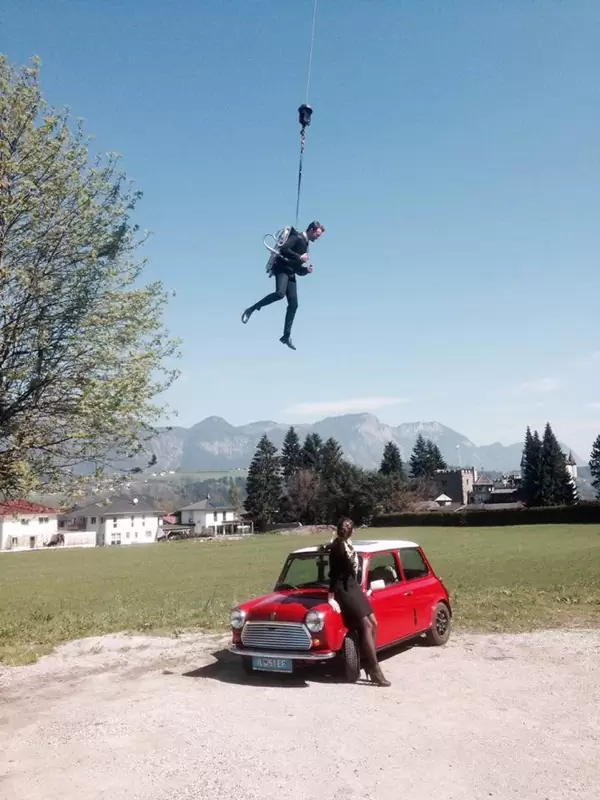 Videoproduktion im James-Bond-Stil: Florian Rudig hängt an einem Seil über einem roten Mini